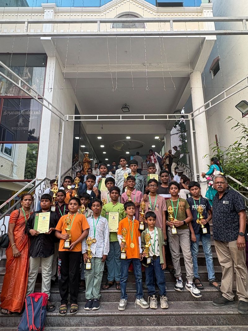 Elite Abacus Academy students pictured with trophies and certificates at an event